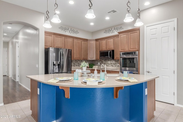 kitchen featuring visible vents, light countertops, light tile patterned floors, and stainless steel appliances