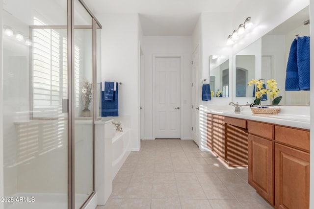 full bathroom featuring tile patterned floors, a shower stall, vanity, and a garden tub
