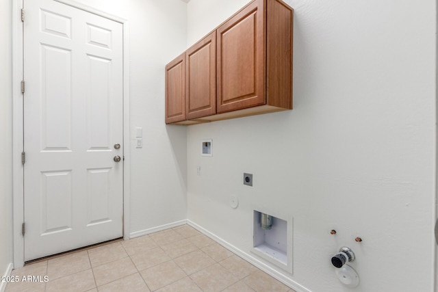 laundry room featuring electric dryer hookup, light tile patterned flooring, washer hookup, hookup for a gas dryer, and cabinet space