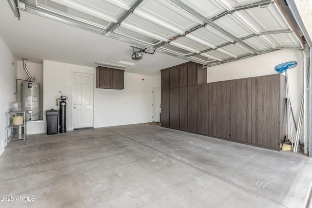 garage featuring gas water heater and a garage door opener