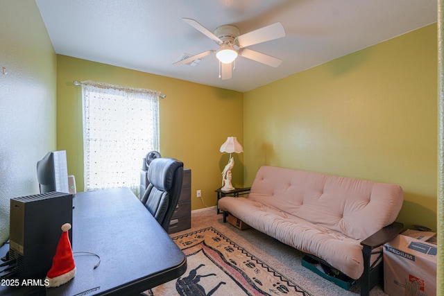 carpeted home office with ceiling fan