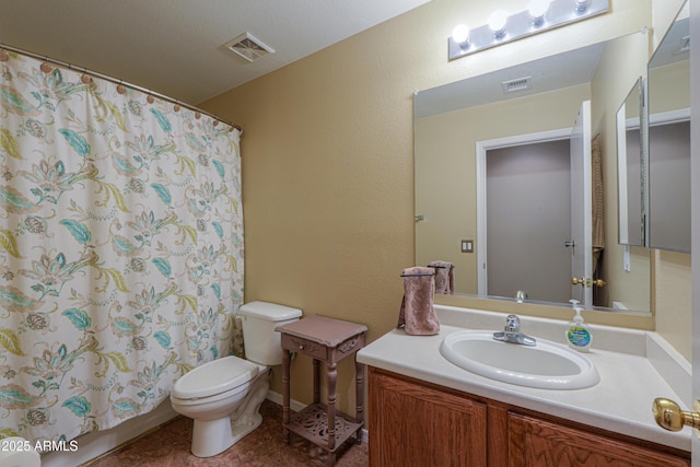 bathroom with vanity, curtained shower, and toilet