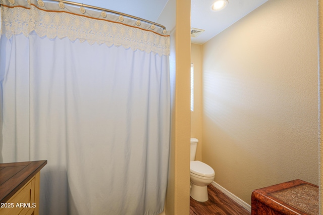 bathroom with hardwood / wood-style floors, vanity, and toilet