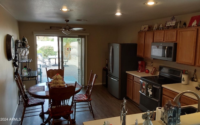 kitchen featuring ceiling fan, stainless steel appliances, and dark wood-type flooring