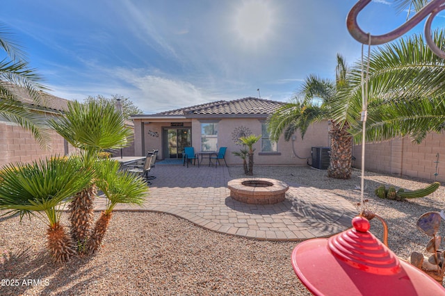 rear view of house featuring central AC, a patio, and a fire pit