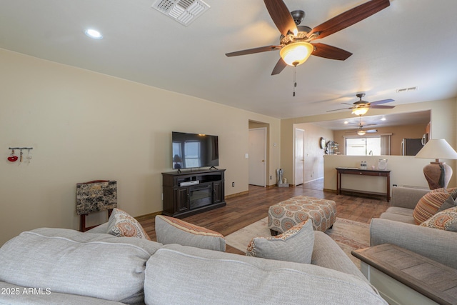 living room with ceiling fan and wood-type flooring