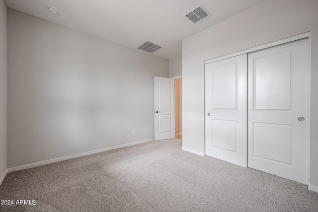 unfurnished bedroom with a closet and carpet floors