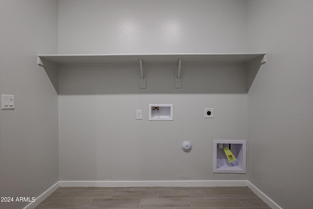 laundry room with hookup for an electric dryer, hookup for a washing machine, and gas dryer hookup