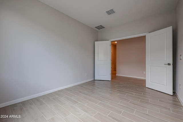 unfurnished room with light wood-type flooring