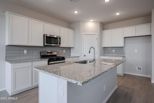 kitchen with white cabinetry, stainless steel appliances, and sink