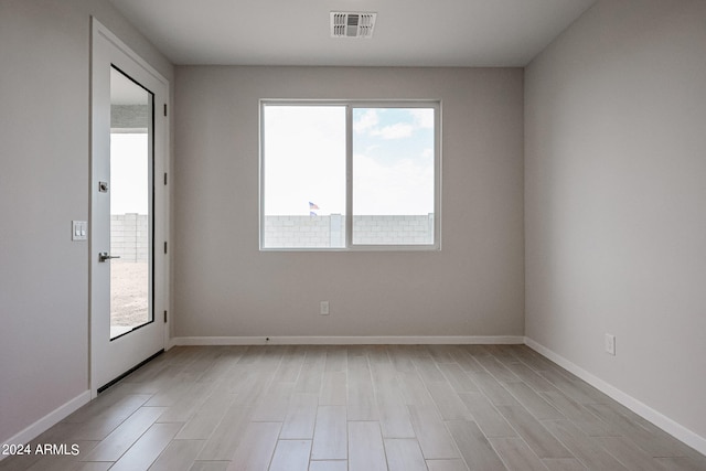 spare room with light hardwood / wood-style floors