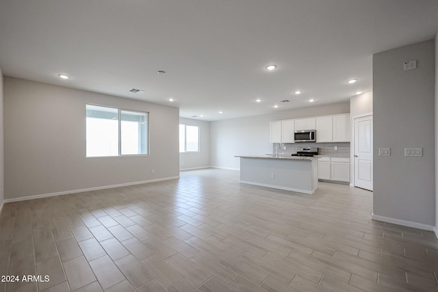 unfurnished living room with light hardwood / wood-style floors