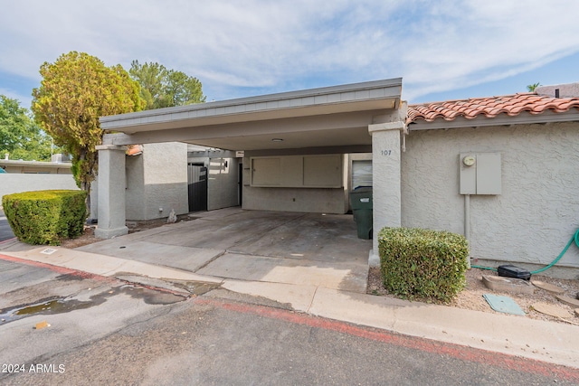 view of car parking featuring a carport and concrete driveway