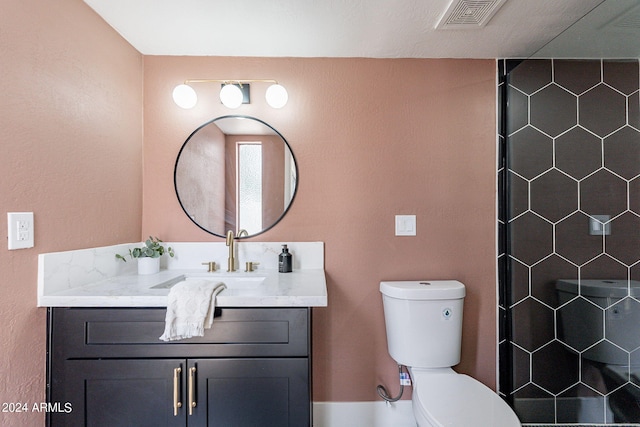 full bathroom featuring vanity, toilet, visible vents, and a tile shower