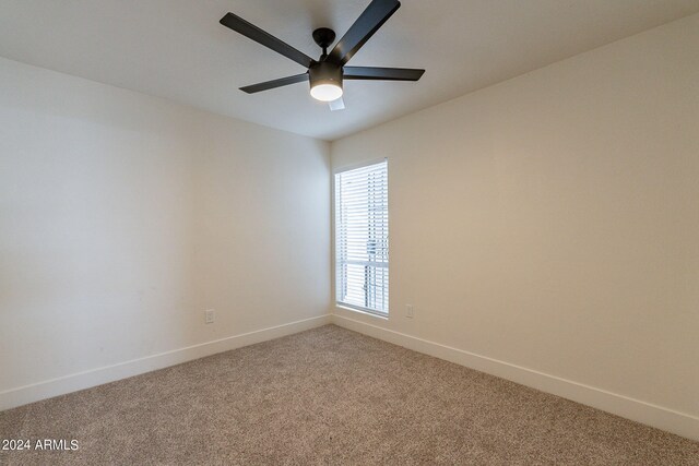 unfurnished room featuring carpet flooring, a ceiling fan, and baseboards