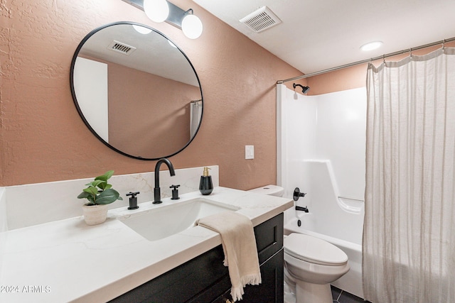 bathroom with visible vents, toilet, vanity, and a textured wall