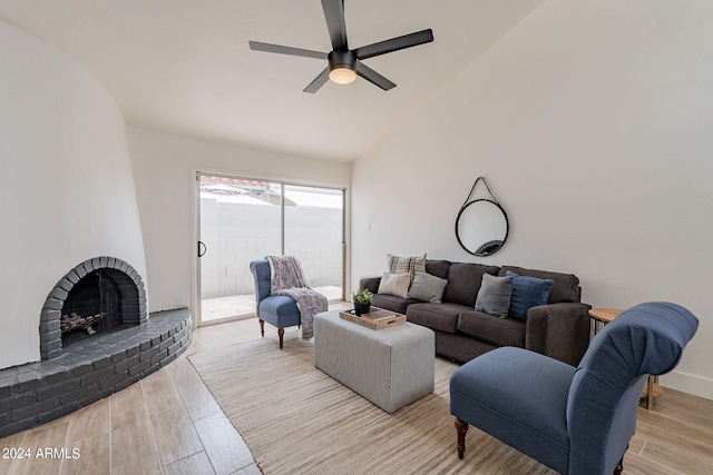 living room with wood finished floors, baseboards, a fireplace, ceiling fan, and vaulted ceiling