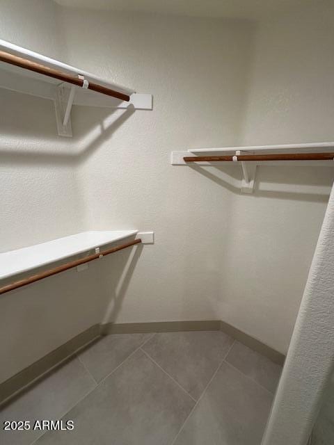 spacious closet featuring tile patterned flooring