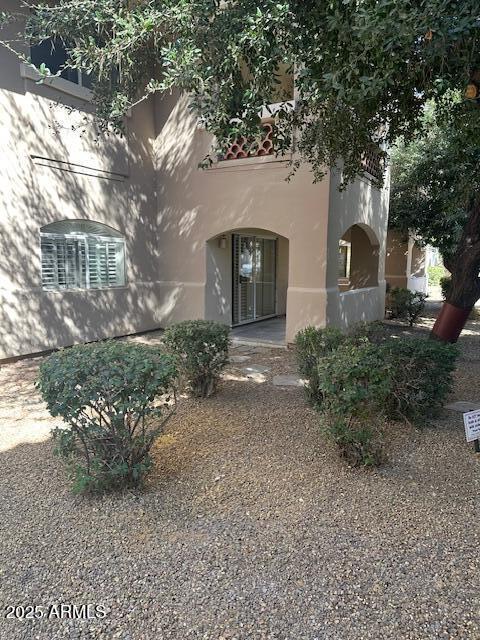 doorway to property featuring stucco siding