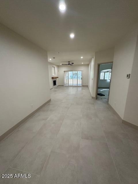 spare room with ceiling fan, baseboards, and recessed lighting