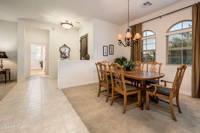 tiled dining space with an inviting chandelier