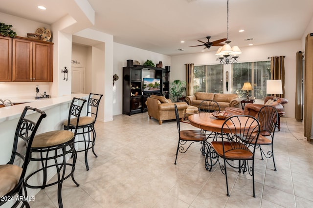 tiled dining space featuring ceiling fan