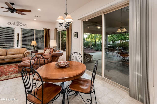 dining room with ceiling fan with notable chandelier and light tile patterned floors