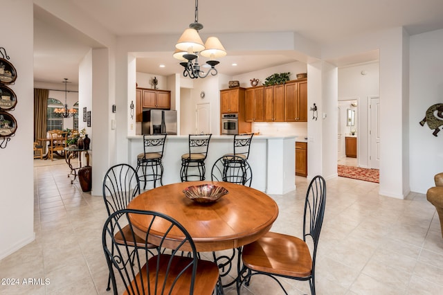 dining room with light tile patterned floors and an inviting chandelier