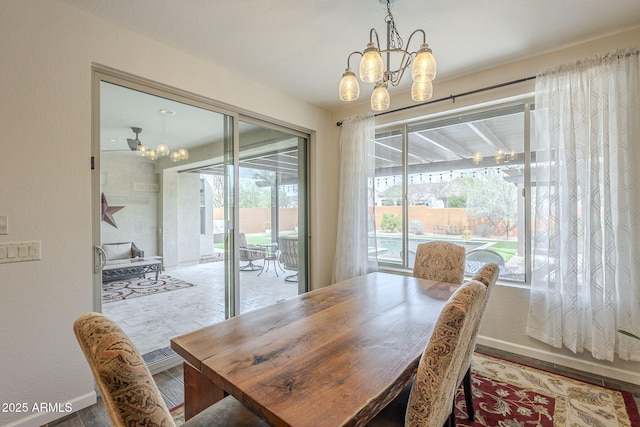 dining area featuring an inviting chandelier and wood finished floors