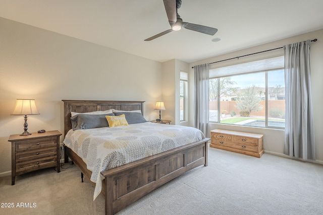 bedroom with a ceiling fan and light colored carpet