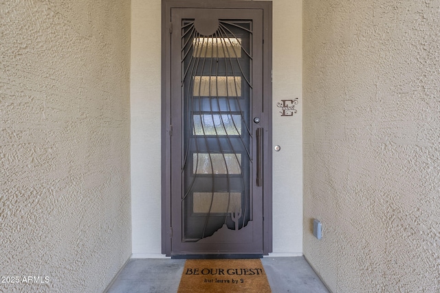 entrance to property with stucco siding