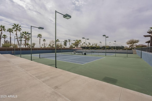 view of tennis court with fence