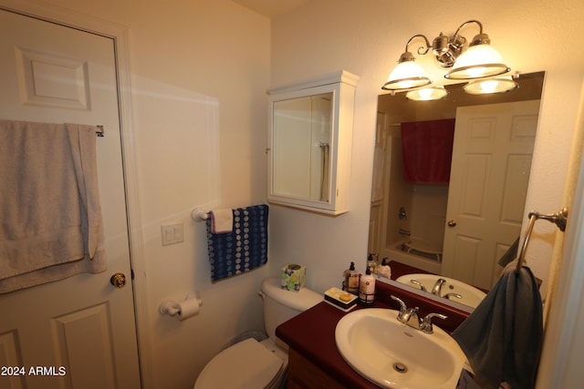 full bathroom featuring toilet, vanity, and  shower combination