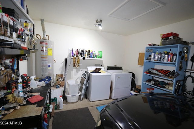 washroom with water heater and independent washer and dryer