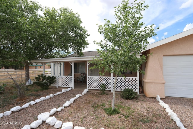 view of front of house with a porch and a garage