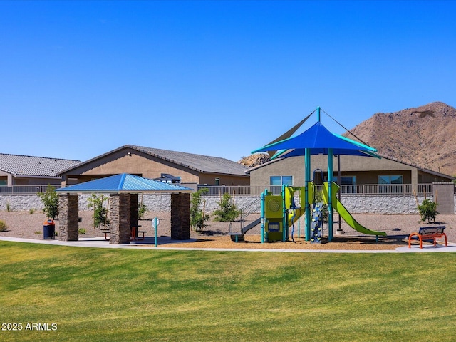 view of jungle gym featuring a mountain view, a gazebo, and a lawn