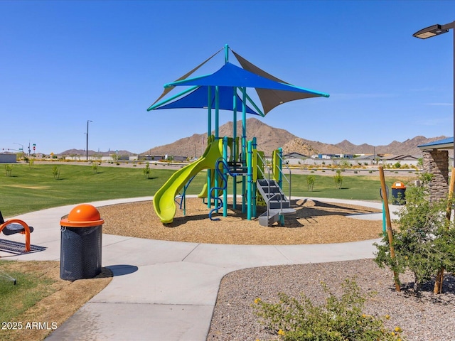 view of play area with a mountain view and a lawn