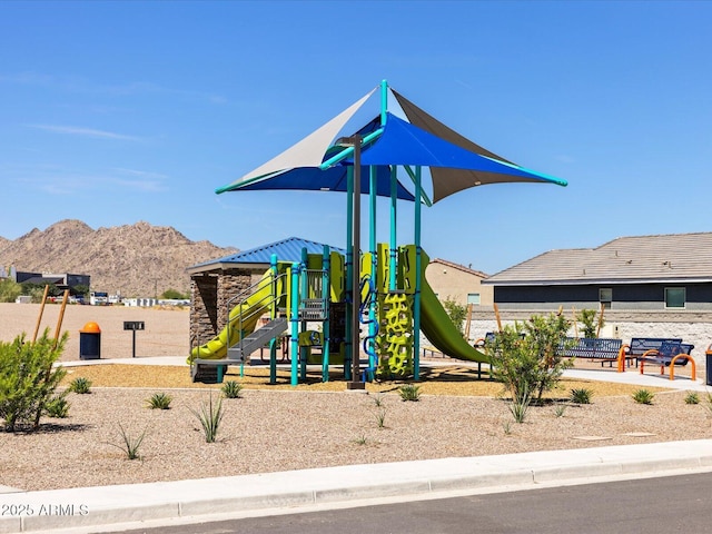 view of jungle gym with a mountain view