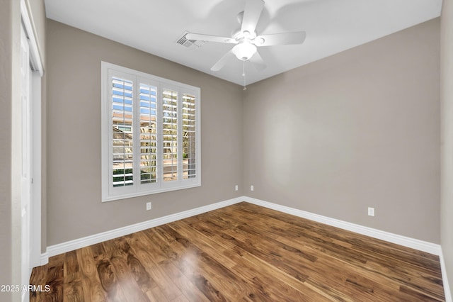 spare room featuring baseboards, a ceiling fan, and wood finished floors