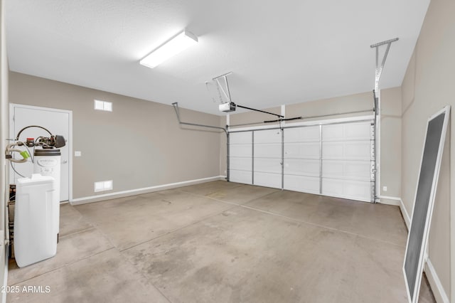 garage with a garage door opener and baseboards