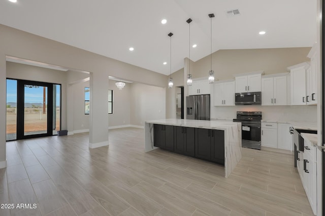 kitchen with black range with electric stovetop, visible vents, white cabinets, stainless steel refrigerator with ice dispenser, and a center island