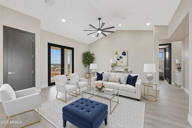 living area with lofted ceiling, recessed lighting, a ceiling fan, visible vents, and baseboards