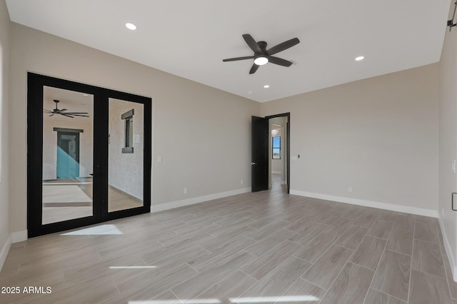 empty room with wood tiled floor, baseboards, a ceiling fan, and recessed lighting