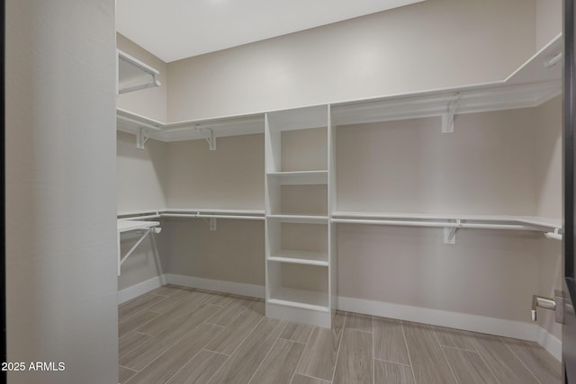 walk in closet with wood tiled floor