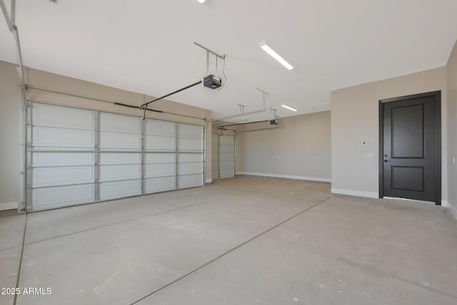 garage with baseboards and a garage door opener