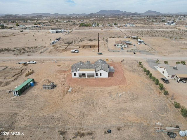 aerial view featuring a mountain view, a desert view, and a rural view