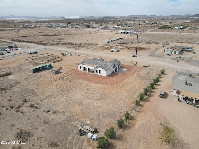 aerial view featuring a rural view, a desert view, and a mountain view