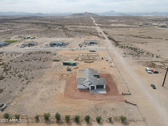 birds eye view of property featuring a rural view, a desert view, and a mountain view