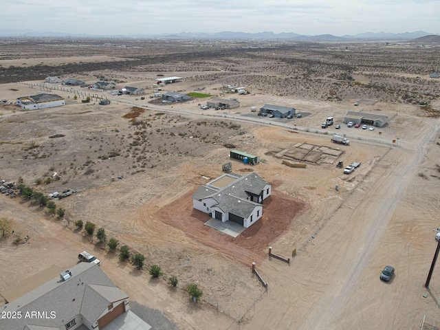 birds eye view of property featuring view of desert, a rural view, and a mountain view