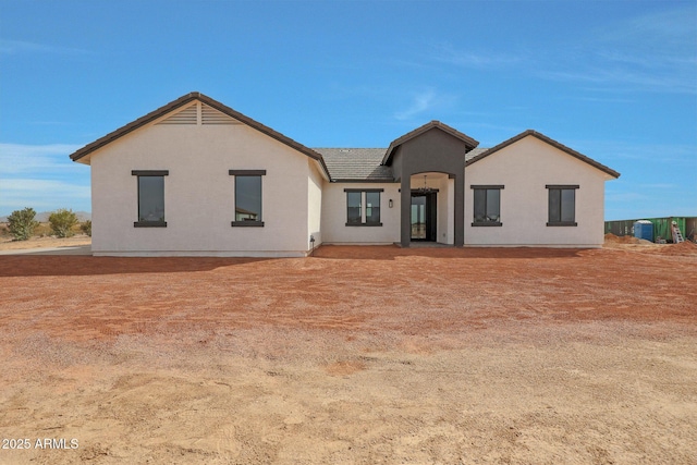 view of front of property featuring a tile roof and stucco siding